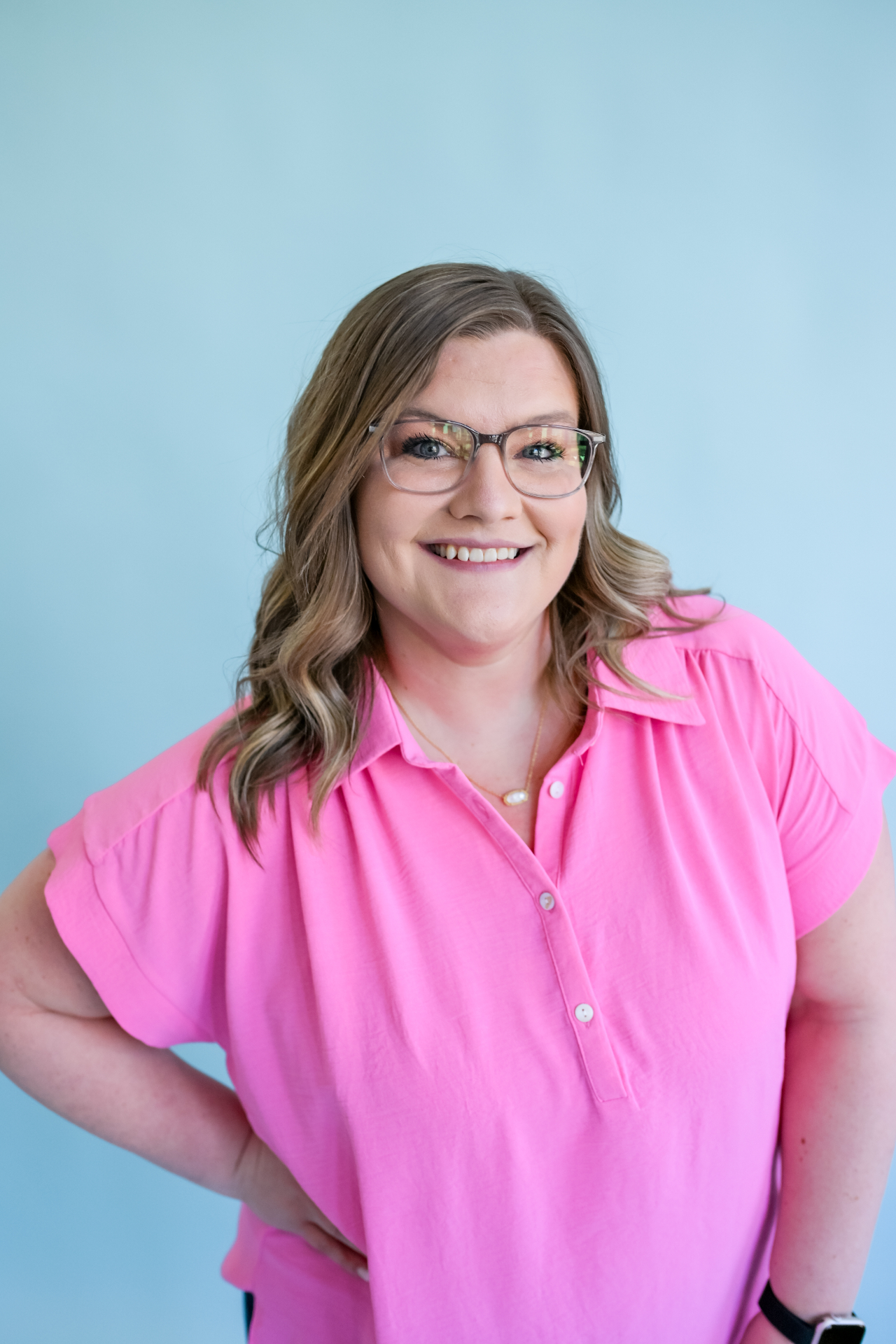 Shelb, your teacher bestie, smiling in a pink shirt